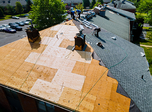 Roof repairs old roof replacement with new shingles of an apartment Roof repairs old roof replacement with new shingles of an apartment building