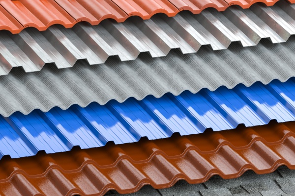 Different types of roof coating. Background from layers of sheet metal  profiles, ceramic tiles, asphalt roofing shingles and gypsum slate.